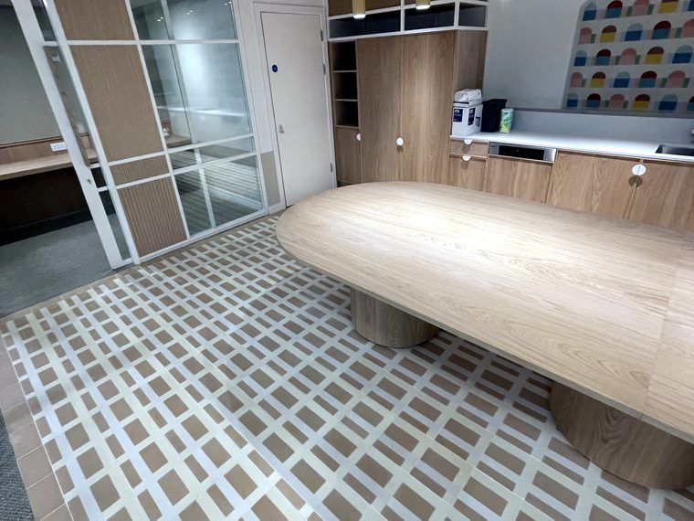 A patterned tiled floor in a workplace cafe at a customer's premises